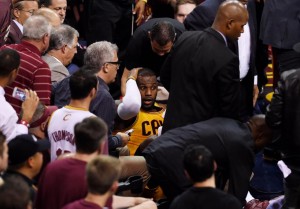 holds his head after falling into the media in the second quarter against the Golden State Warriors during (credit Photo by Jason Miller/Getty Images)