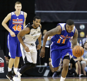 New York's Ricky Ledo (11) drives the ball ahead of San Antonio's Brandon Davies (0) during the second half of an NBA summer league basketball game Saturday, July 11, 2015, in Las Vegas. New York's Kristaps Porzingis (46) watches nearby. New York won 78-73. (AP Photo/Ronda Churchill)