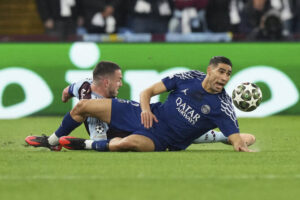 PSG’s Achraf Hakimi, right falls after a challenge by Aston Villa’s John McGinn during their Champions League quarterfinal second leg soccer match at the Villa Park stadium, in Birmingham, Apr. 15, 2025. (AP)